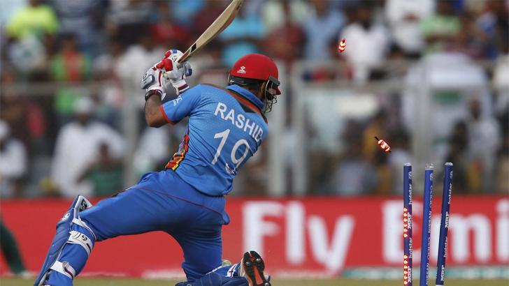 Despite losing his middle stump in this image, Rashid Khan is a more than useful lower-middle order  batsman who likes to clear the boundary rope. 